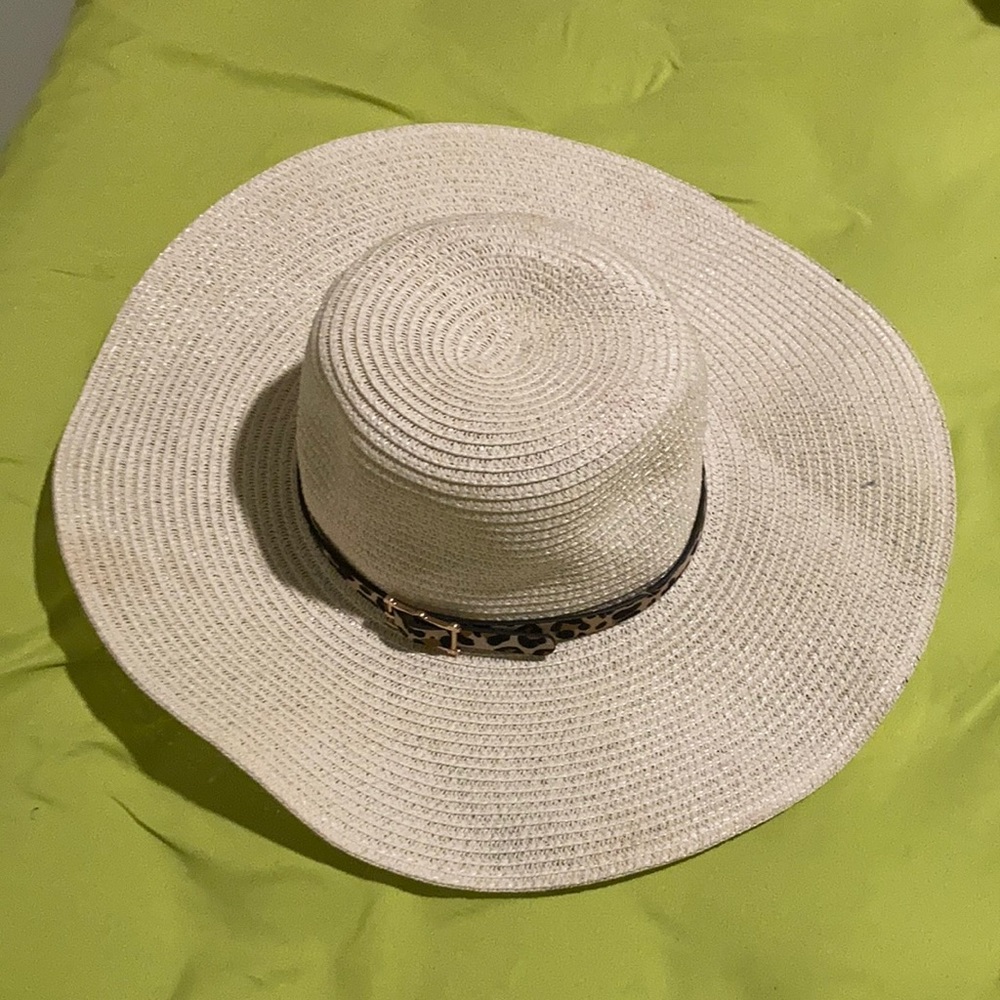 Large brim floppy straw hat with animal tie. Worn once it twice.